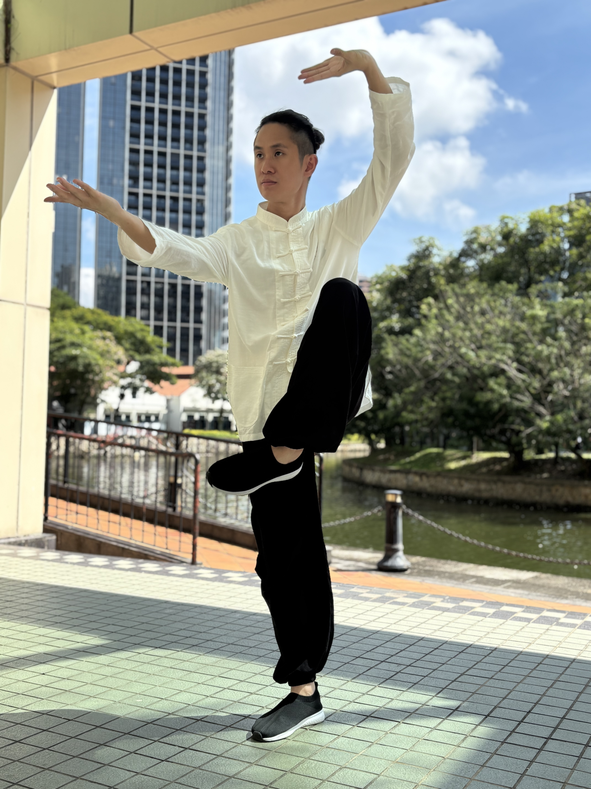 Person practicing Ba Duan Jin outdoors to improve flexibility, balance, and overall well-being